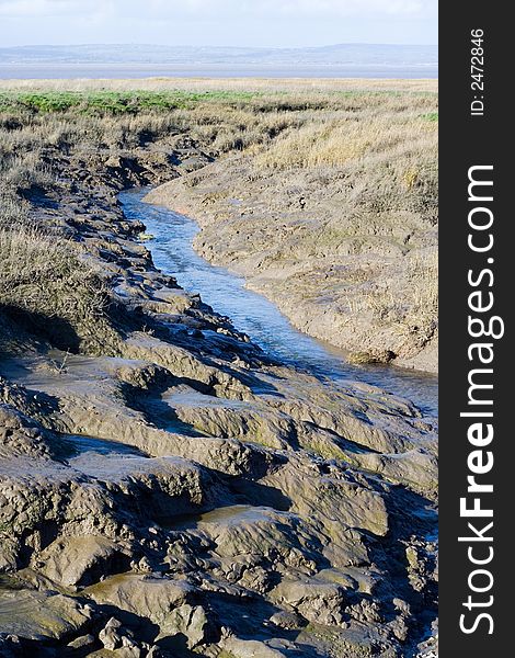 Muddy stream leading away accross salt plain. Muddy stream leading away accross salt plain