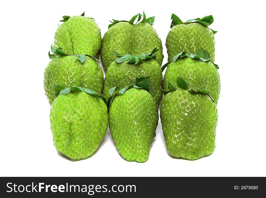 Green unripe Strawberries on a white background