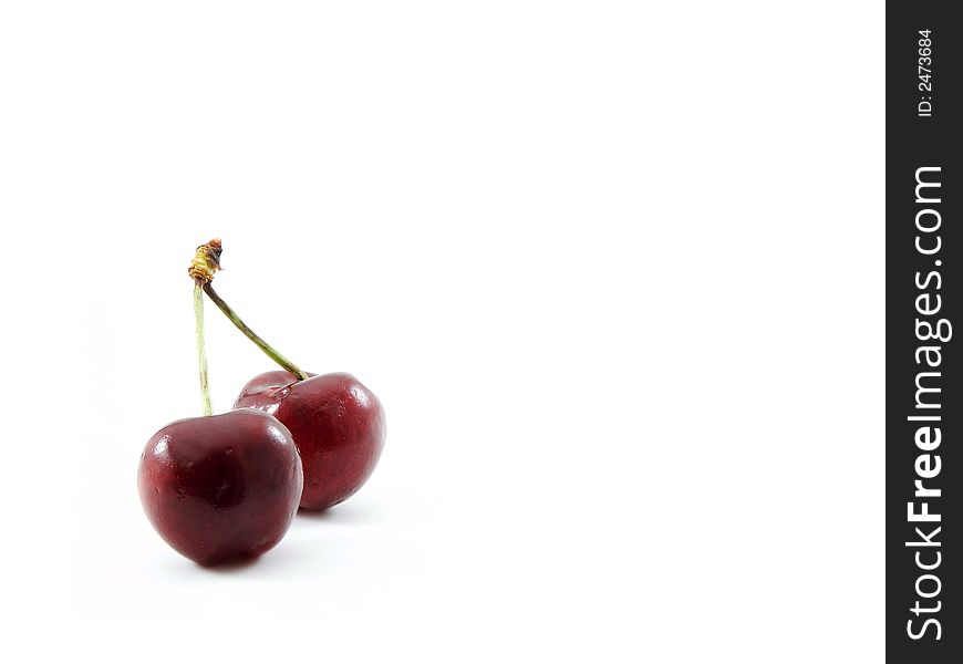 Two cherries isolated on a white background