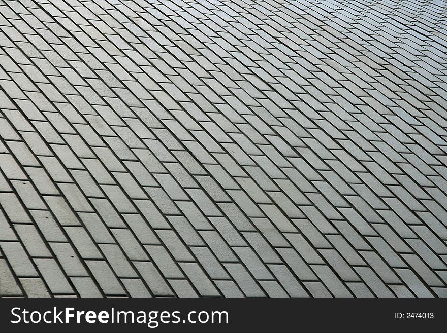 Background from a tile with geometrical figure laid on sidewalk.