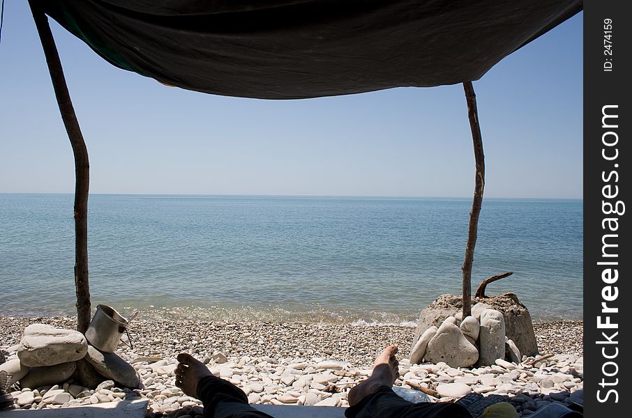 Sombody lie on a beach in shadow. Sombody lie on a beach in shadow