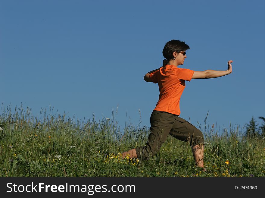 Woman making of the stretching in full nature. Woman making of the stretching in full nature