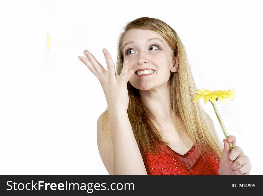 Attractive blond plukcing petals from a daisy. Attractive blond plukcing petals from a daisy