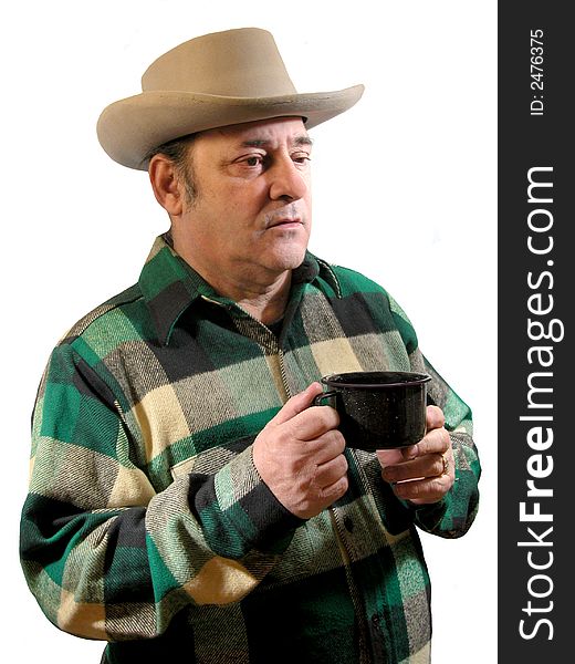 A man in a green plaid shirt and a western hat with a cup of coffee in his hand,over white. A man in a green plaid shirt and a western hat with a cup of coffee in his hand,over white