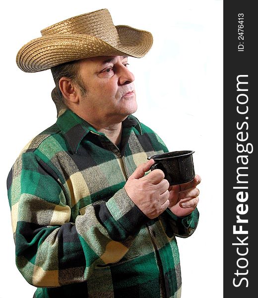 A man in a straw cowboy hat enjoying a cup of coffee, over white. A man in a straw cowboy hat enjoying a cup of coffee, over white