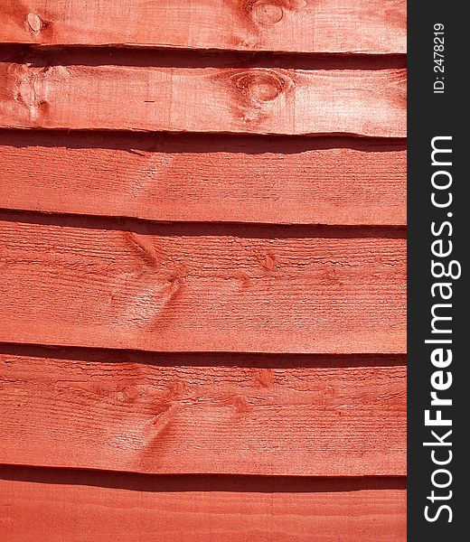 Close-up photo of a stained fence panel