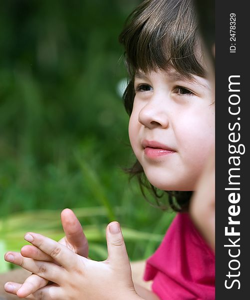 Little girl looking and listening to a little boy in the garden