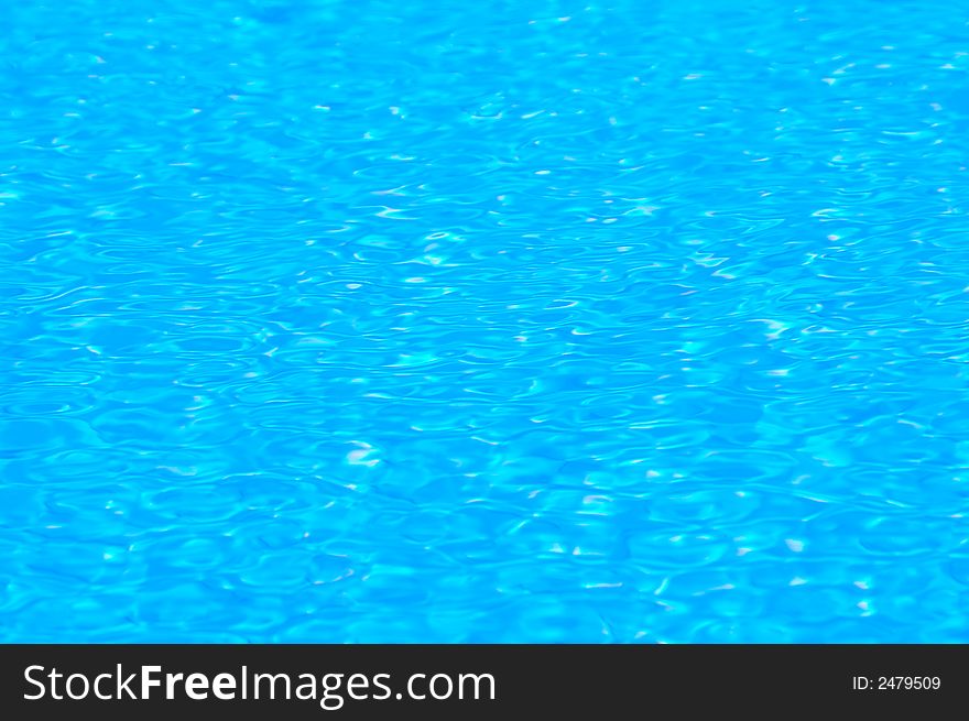 Water in a swimming pool taken at midday with a close-up lens to capture a small detail of the ripples on the surface created by a warm tropical wind. Taken with a Nikon D50 camera with 105mm macro lens. 1/250 sec at F16. Water in a swimming pool taken at midday with a close-up lens to capture a small detail of the ripples on the surface created by a warm tropical wind. Taken with a Nikon D50 camera with 105mm macro lens. 1/250 sec at F16.