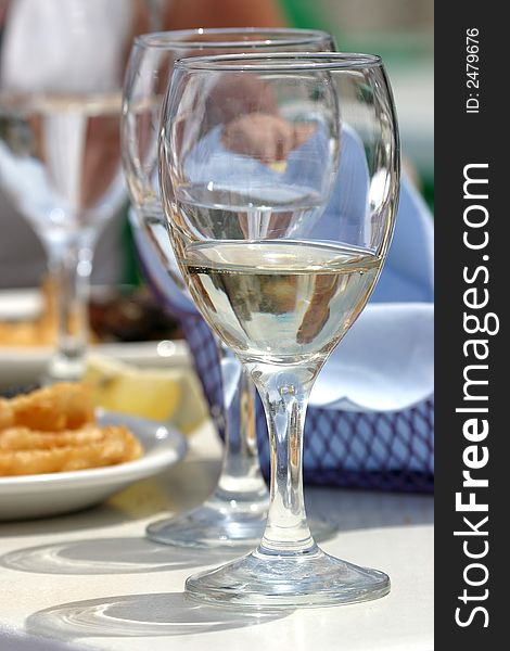 Diversity of fried fish on plate with glass of water. Diversity of fried fish on plate with glass of water