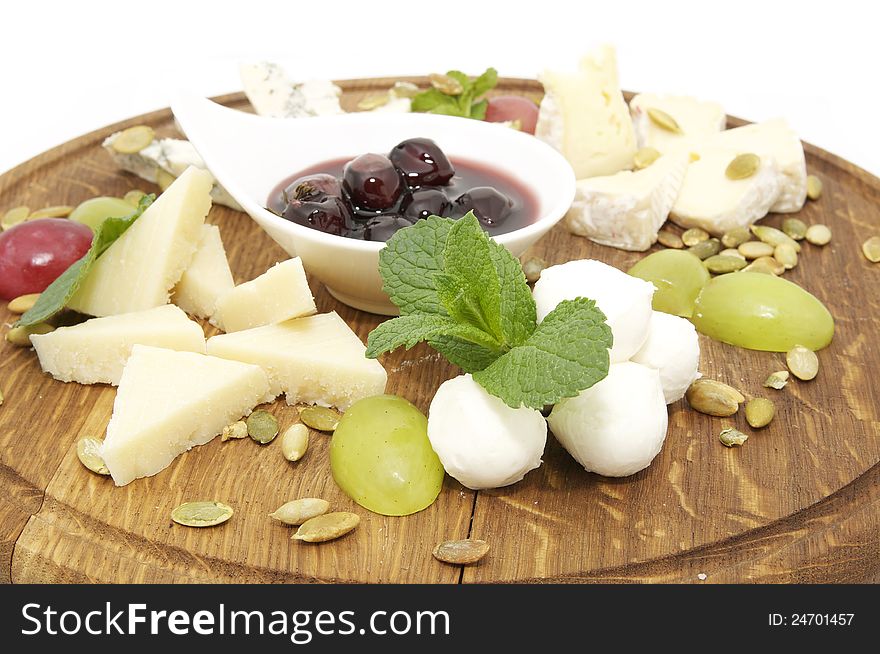 Cheese plate with several kinds of cheese on a white background