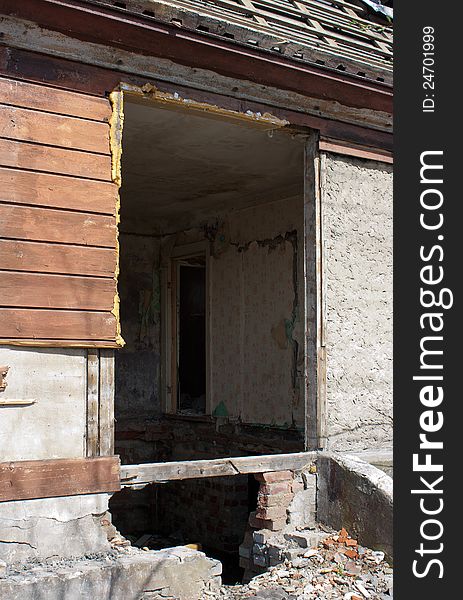 Door and room of abandoned broken house in sunny spring day