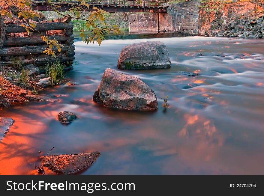 River landscape with the bridge stones and an old timbered felling