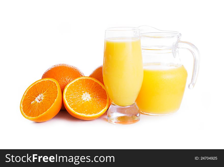 Orange juice in jug and glass over white