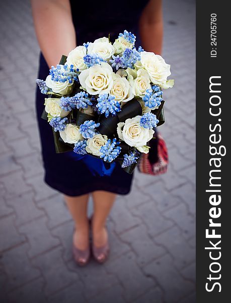 Bridesmaid holding colorful wedding bouquet