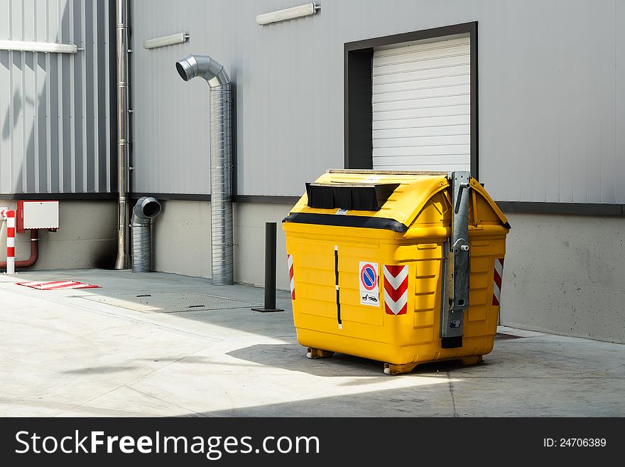 Yellow garbage can for plastic recycling  in warehouse. Yellow garbage can for plastic recycling  in warehouse.