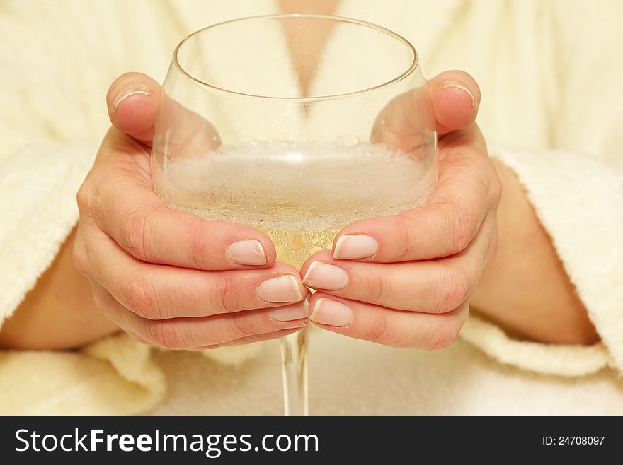 Hands holding wine glass with bubbly liquid. Hands holding wine glass with bubbly liquid.