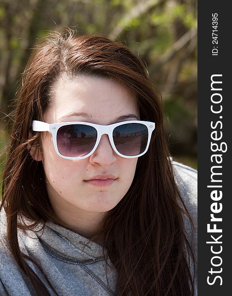 A Teen girl with sunglasses on. A Teen girl with sunglasses on.