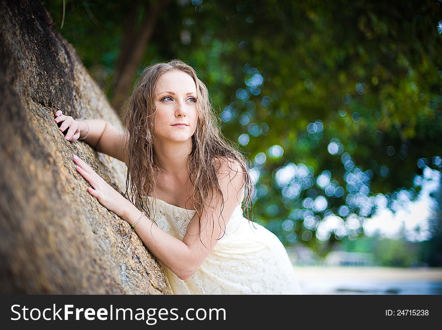 A beautiful young girl in a white dress with a sto