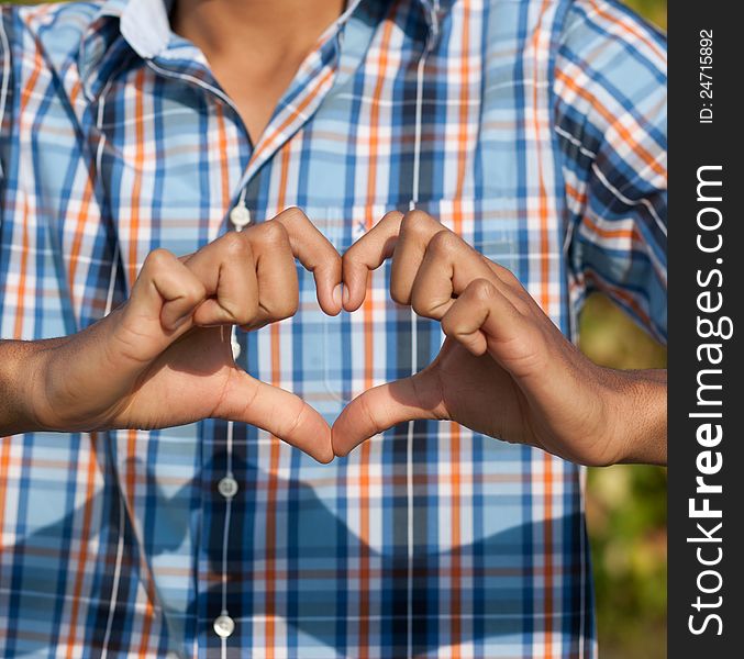 Young man show love sign outdoor