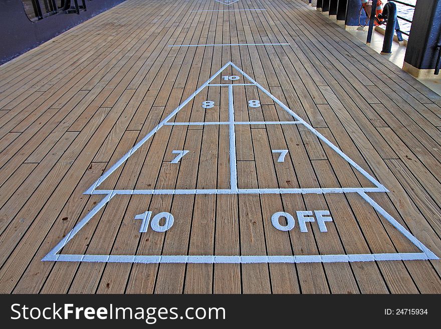 Shuffleboard onboard a cruise line ship on a wooden deck