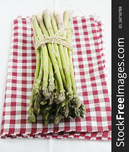 Bunch of fresh green asparagus on colorful napkin. Bunch of fresh green asparagus on colorful napkin