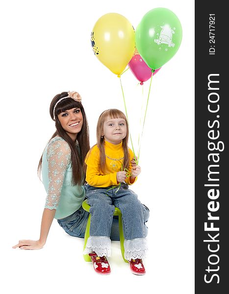 Mother and his daughters with colorful balloons. studio shoot over white background. Mother and his daughters with colorful balloons. studio shoot over white background
