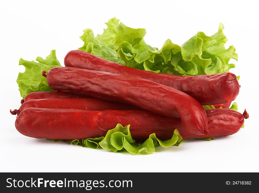 Sausage arranged with lettuce on white background