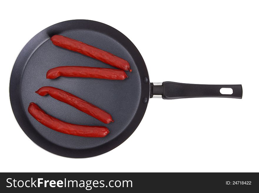 Fried sausages on frying pan isolated on a white