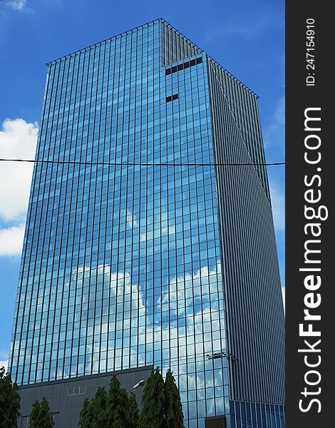 Tower in bangkok on blue sky with cloud reflect
