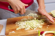 Female Hands Slicing Cabbage Royalty Free Stock Photo