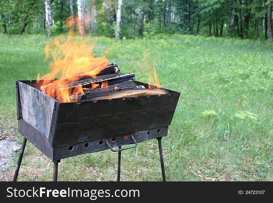 Burning wood in a brazier in the summer