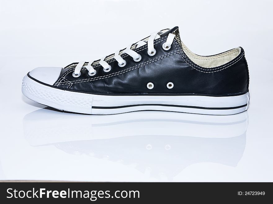 Black leather sneaker on white background