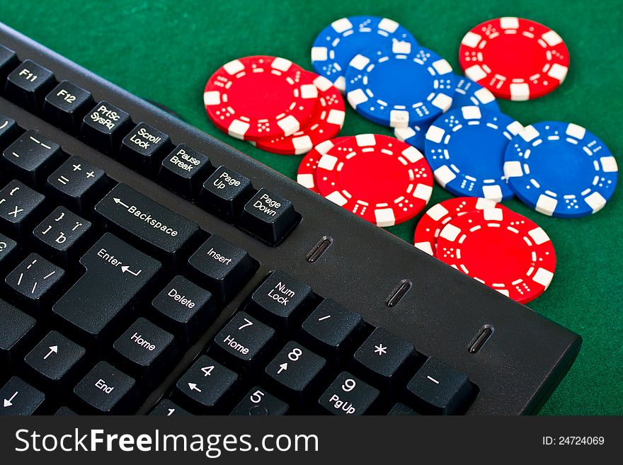 Fragment of the black modern keyboard of computer with gamble chips. Fragment of the black modern keyboard of computer with gamble chips.