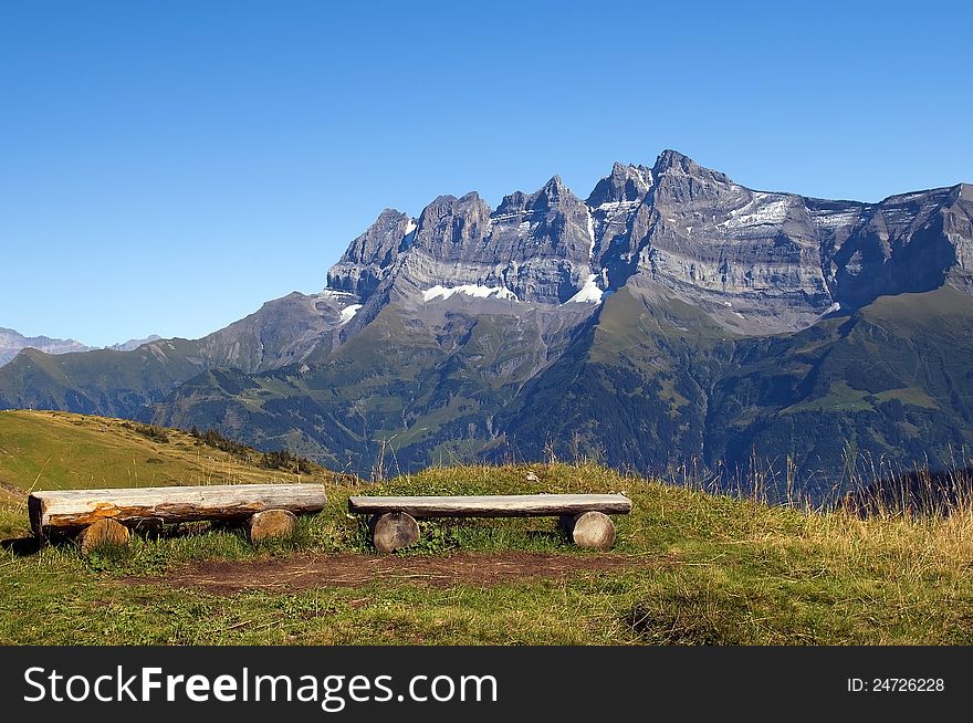 Observation deck with wooden benches in the Swiss Alps. Observation deck with wooden benches in the Swiss Alps