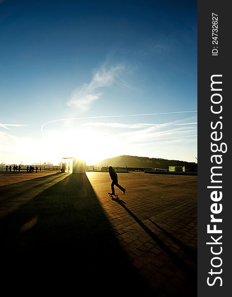 Tall shadows during sunset and a skater silhouette