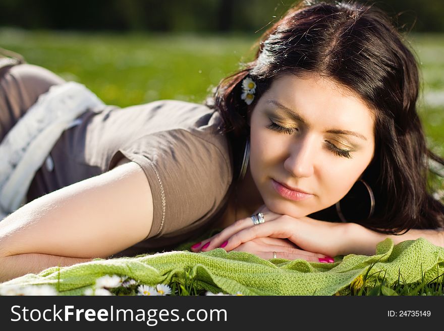 Beautiful Girl Lying On The Plaid In The Park