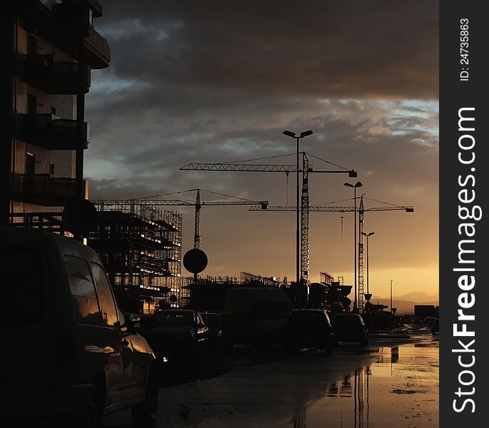 Sunset above building site with cranes