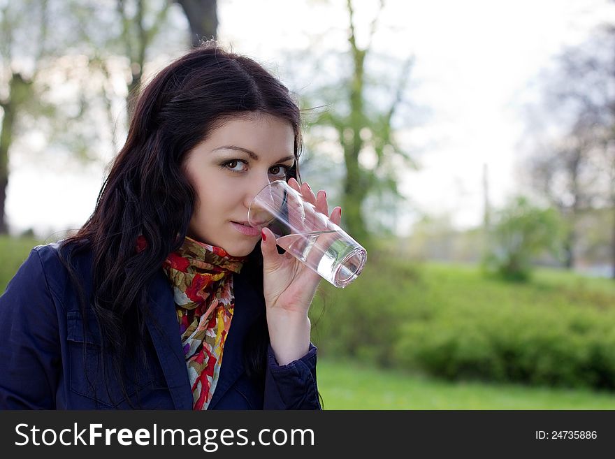 Young woman with glass of water, outdoors. Young woman with glass of water, outdoors