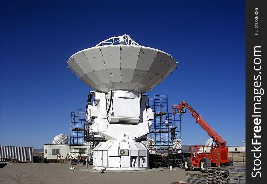 A construction crew works to complete a radio astronomy telescope at the very large array (VLA) located in new mexico, USA;. A construction crew works to complete a radio astronomy telescope at the very large array (VLA) located in new mexico, USA;