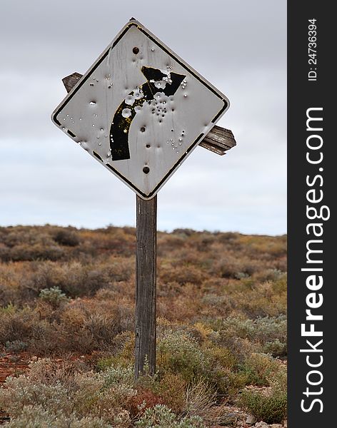 Bullet ridden street sign in the outback. Bullet ridden street sign in the outback