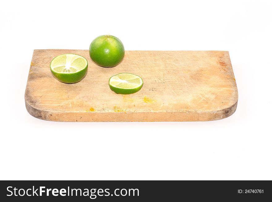 Limes slice on wooden block isolated on white background