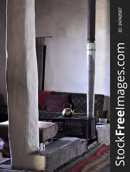 An old coal heater within a sitting room in a Lebanese village. An old coal heater within a sitting room in a Lebanese village