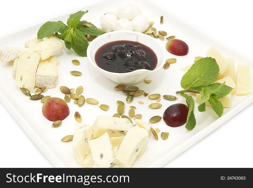 Cheese plate with several kinds of cheese on a white background