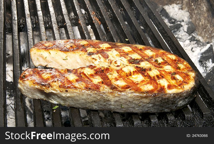 Salmon steak cooked on a grill in the restaurant