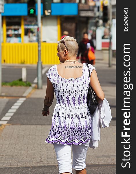 Tattooed woman crossing a road