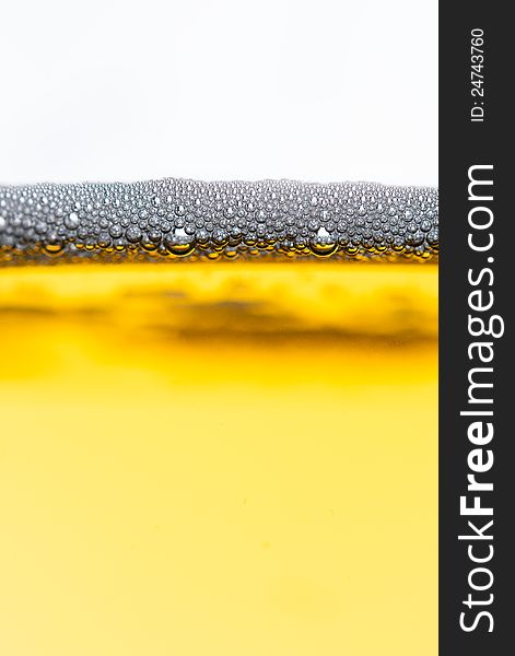 Fresh beer with froth and condensed water pearls on white  background. Fresh beer with froth and condensed water pearls on white  background