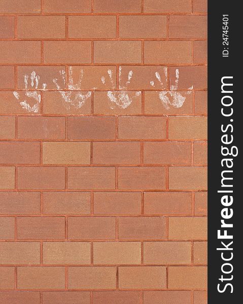 Hand marks on the brick wall.