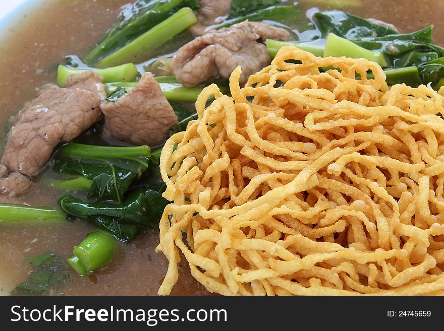 Crispy yellow noodle with in a creamy gravy sauce