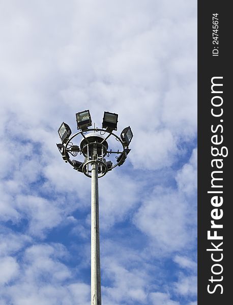 Spot-light tower in blue sky with cloud