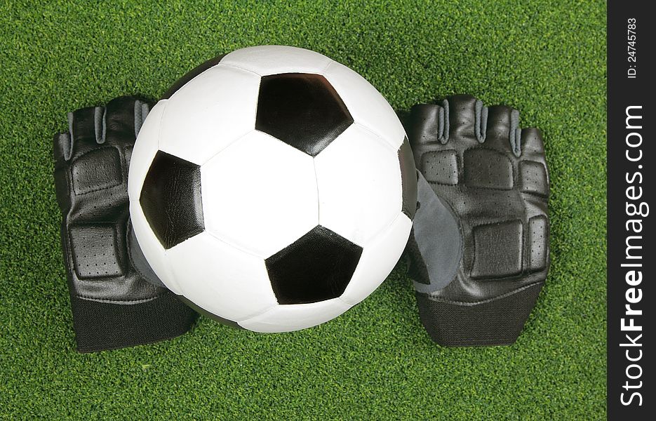 Soccer ball with glove on green grass. Soccer ball with glove on green grass